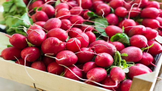 radish in wicker baskets on the counter of market