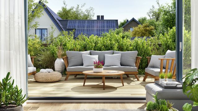 Rooftop patio with sliding doors and house with solar panels